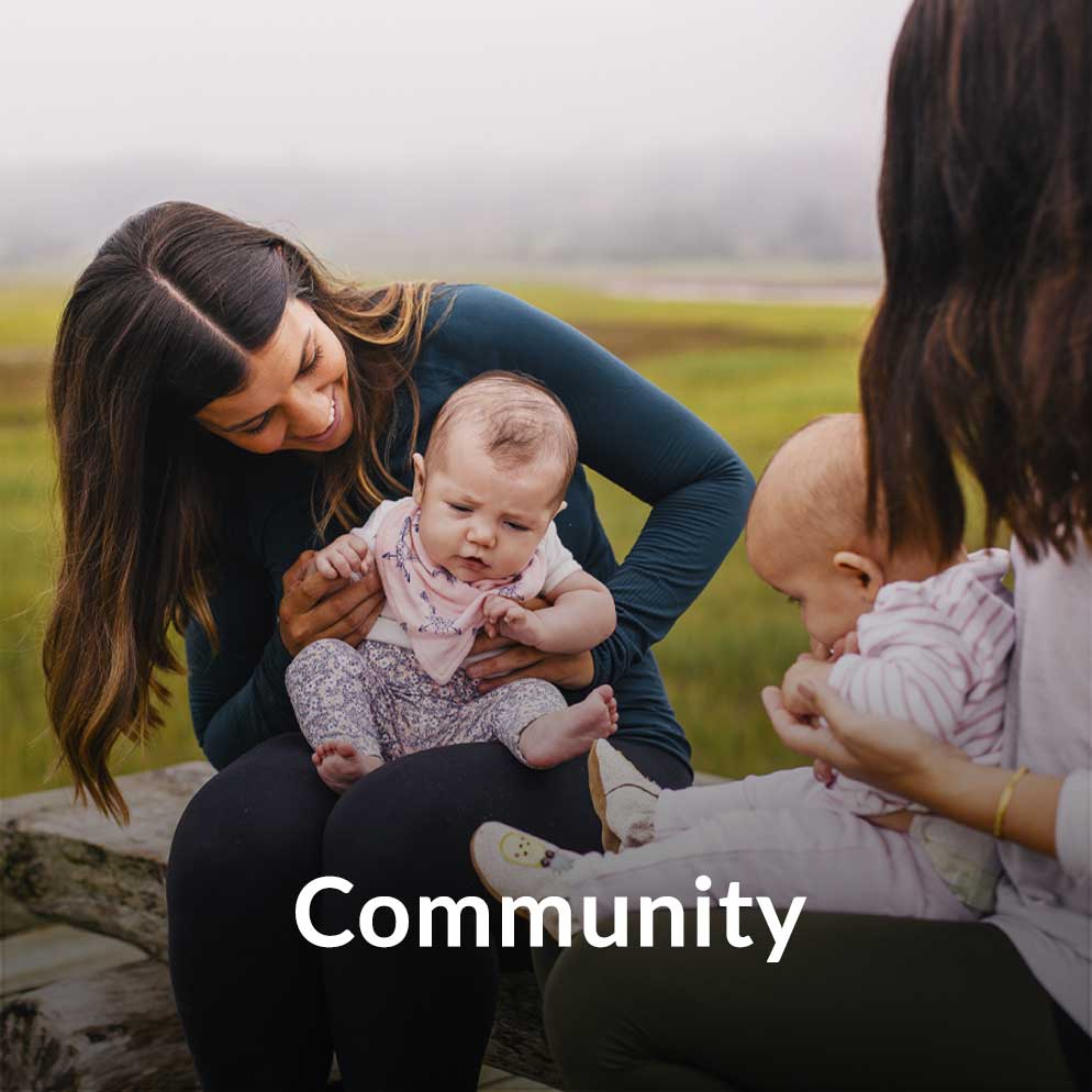 Two women outdoors with their infants