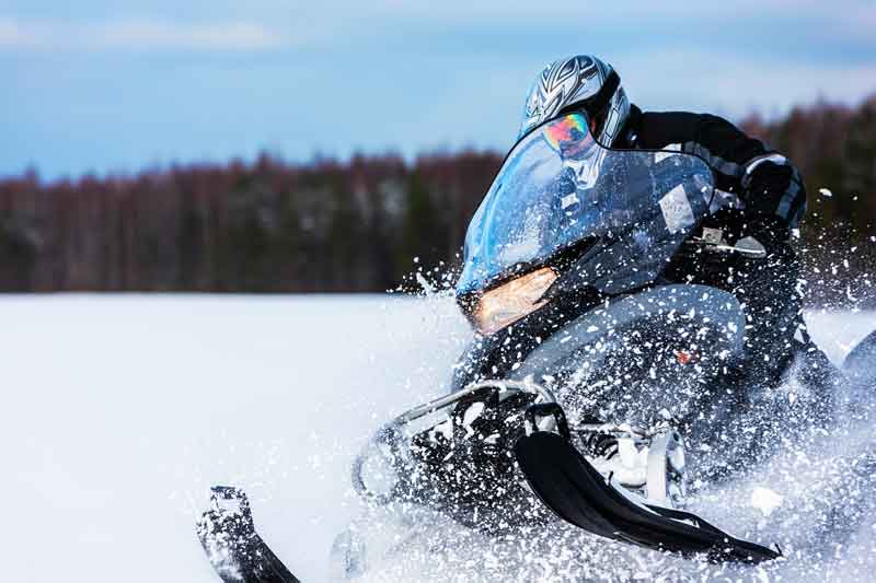 High-action shot of a snowmobile in use